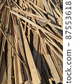 Pile of wooden planks and scraps from a sawmill 87553618