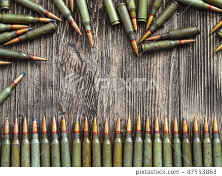 Weapon ammo on a dark wooden background. Weapon ammo on a dark wooden background. 87553863
