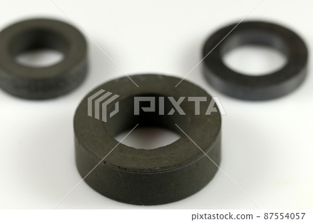 Black ferrite rings for making inductors. Rings of various sizes. Selective focus. Electronic components. 87554057