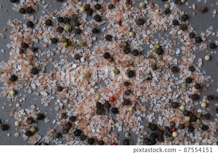 Background with pink salt crystals and different types of peppers. Pattern. Background with pink salt crystals and different types of peppers. Pattern. 87554151