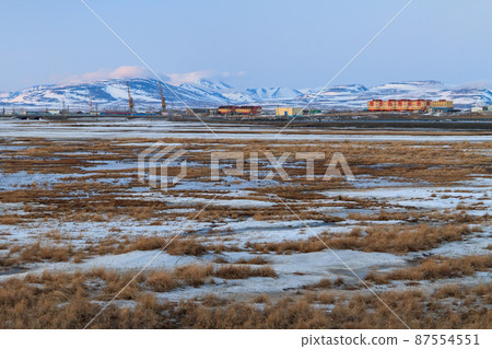 Spring arctic landscape. View of the tundra, colorful buildings and mountains 87554551