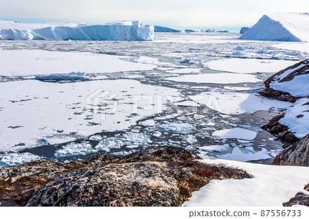 Ice fields and drifting Icebergs at the Ilulissat fjord, North Greenland Ice fields and drifting Icebergs at the Ilulissat fjord, North Greenland 87556733