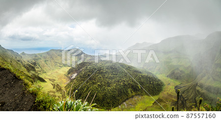 La Soufriere volcano crater panorama with tuff cone hidden in green and pouring rain, Saint Vincent and the Grenadines 87557160
