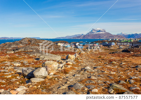 Autumn greenlandic tundra, Inuit settlement and Sermitsiaq mountain, Nuuk, Greenland 87557577