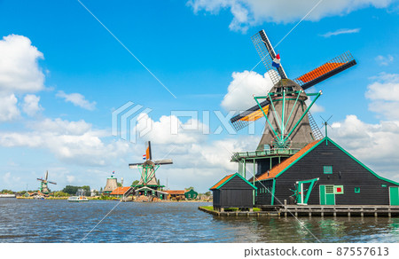 Colorful Dutch Windmills at the river Zaan, Zaanse Schans, Zaandam, The Netherlands 87557613