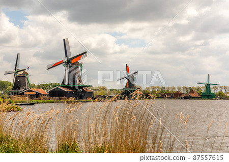 Colorful Dutch Windmills at the river Zaan, Zaanse Schans, Zaandam, The Netherlands Colorful Dutch Windmills at the river Zaan, Zaanse Schans, Zaandam, The Netherlands 87557615