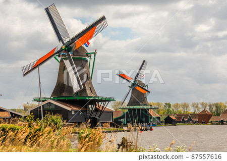 Colorful Dutch Windmills at the river Zaan, Zaanse Schans, Zaandam, The Netherlands Colorful Dutch Windmills at the river Zaan, Zaanse Schans, Zaandam, The Netherlands 87557616