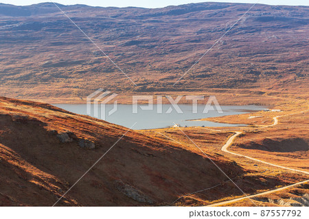 Autumn greenlandic orange tundra landscape, Kangerlussuaq, Greenland 87557792