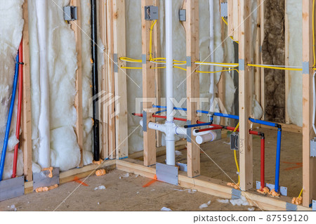Buildt new home construction featuring hot and cold water PEX plastic plumbing tubes. 87559120