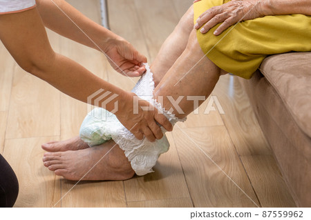 Urinary Incontinence in elderly and changing diaper. Urinary Incontinence in elderly and changing diaper. 87559962