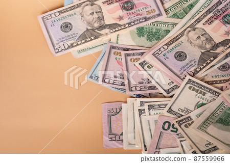 American dollars paper banknotes. Dollars on a beige background. American dollars paper banknotes. Dollars on a beige background. 87559966