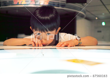 A boy experimenting at a science museum A boy experimenting at a science museum 87560163