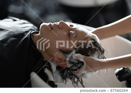 A man who gets shampooed at a beauty salon A man who gets shampooed at a beauty salon 87560264
