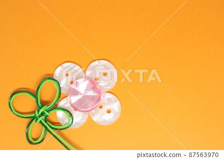Background with handicraft buttons and mizuhiki work Clover and flowers Background with handicraft buttons and mizuhiki work Clover and flowers 87563970