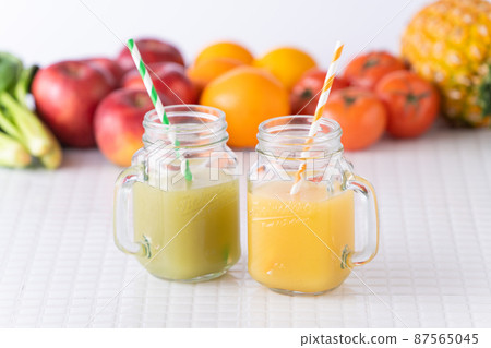 Orange smoothie and green smoothie 87565045