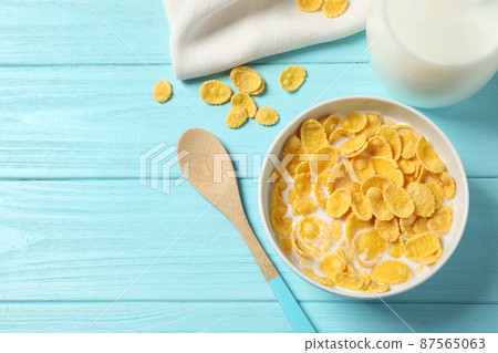 Flat lay composition with tasty corn flakes on light blue wooden table Flat lay composition with tasty corn flakes on light blue wooden table 87565063
