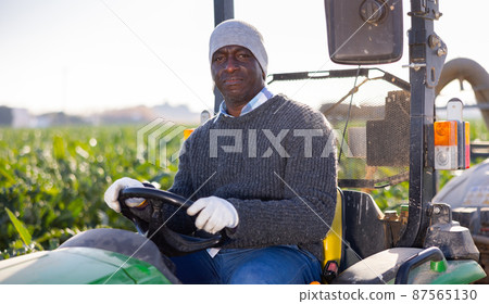 African-american man driving tractor on plantation African-american man driving tractor on plantation 87565130