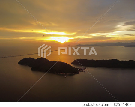 Aerial view dramatic sunset cloud over Pulau Aman Island 87565402