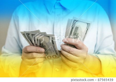 Economic crisis. Businessman recounts dollar bills money to pay bills, loans and services. War in Ukraine. Business finance saving and investment concept. 87565439