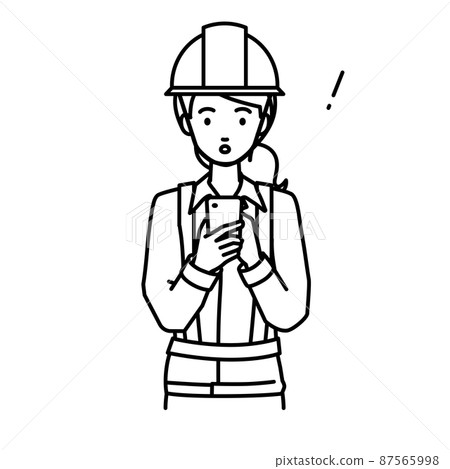 A woman at a construction site who was surprised to notice something while standing and operating a smartphone A woman at a construction site who was surprised to notice something while standing and operating a smartphone 87565998