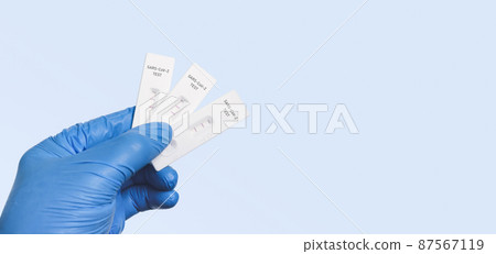 The doctor showing Covid-19 positive test result with SARS CoV-2 Rapid antigen test kit (ATK) 87567119