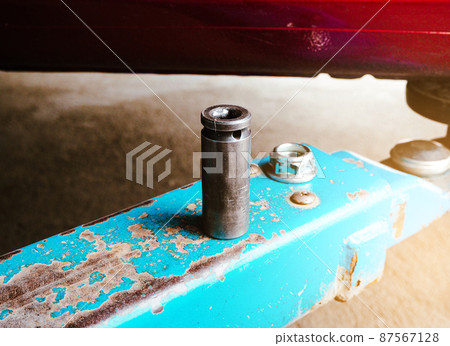 Metal block of air impact wrench on the car hydraulic lift Metal block of air impact wrench on the car hydraulic lift 87567128