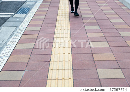 Braille blocks and walking women's feet Braille blocks and walking women's feet 87567754