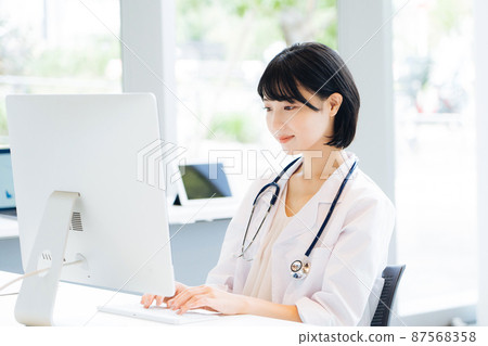 Female doctor doing desk work 87568358