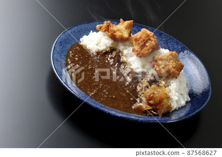 Photographed hot fried curry with Fukujinzuke on a black background Photographed hot fried curry with Fukujinzuke on a black background 87568627