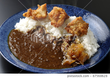 Photographed hot fried curry with Fukujinzuke on a black background Photographed hot fried curry with Fukujinzuke on a black background 87568628