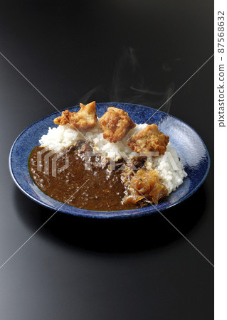 Photographed hot fried curry with Fukujinzuke on a black background Photographed hot fried curry with Fukujinzuke on a black background 87568632