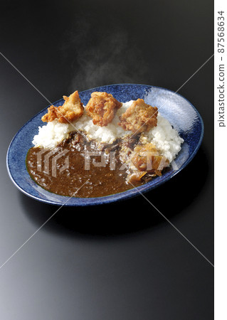 Photographed hot fried curry with Fukujinzuke on a black background Photographed hot fried curry with Fukujinzuke on a black background 87568634