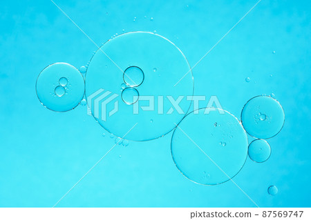 Oil and water bubbles on blue background. Abstract oil bubbles background. Oil and water bubbles on blue background. Abstract oil bubbles background. 87569747
