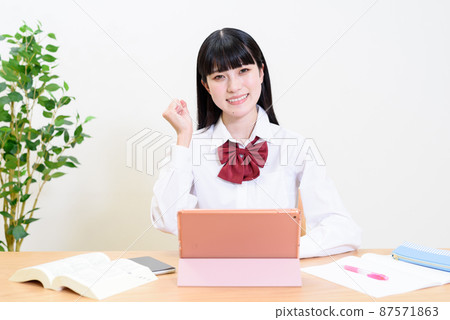 High school girls studying while using a tablet terminal Video viewing Online class Video call Guts pose 87571863