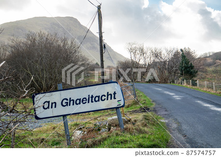 An Ghaeltacht road sign explaining that here starts an area where the irish language is spoken - Translation: Irish 87574757