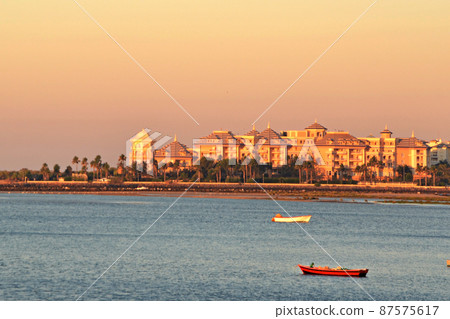 Beautiful sunset on the beach on a summer morning with the boats in the foreground Beautiful sunset on the beach on a summer morning with the boats in the foreground 87575617