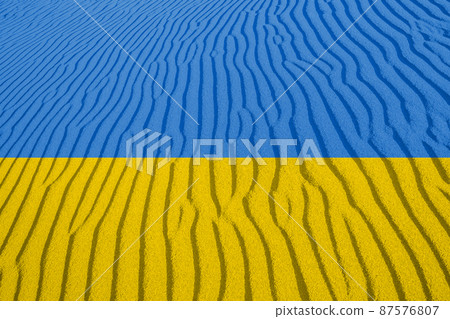 Ukrainian national flag with sand pattern, war concept 87576807