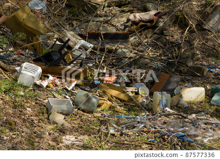 Mountain garbage in the forest. Garbage in the forest - dump in the woods. Mountain garbage in the forest. Garbage in the forest - dump in the woods. 87577336