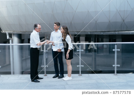 business colleagues greeting each other in the corridor of the business center. 87577578