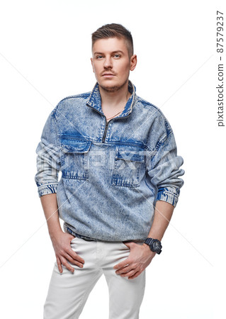 handsome young man in Jean jacket on white background 87579237