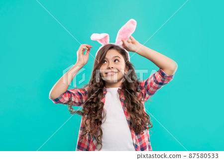 happy child girl in easter bunny ears having fun, easter fun 87580533