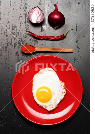 Food placed on red plate on black background, top view 87580629