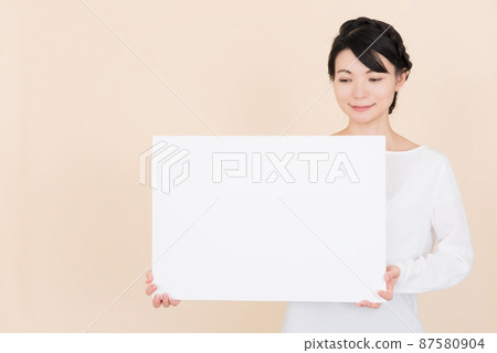 Woman in white blouse with whiteboard 87580904