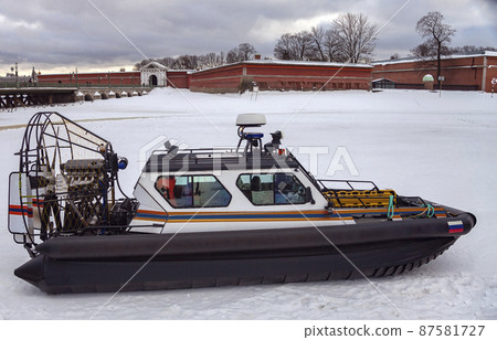 View of the airboat of the search and rescue service of St. Petersburg on the ice against the background of the Peter and Paul Fortress. 87581727
