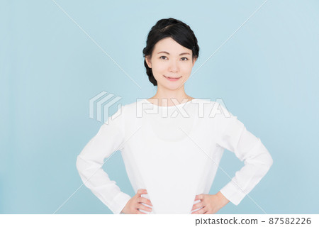 一個穿著白色襯衫、雙手叉腰的女人 一個穿著白色襯衫、雙手叉腰的女人 87582226