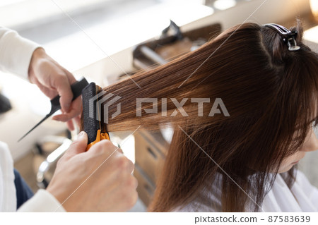 A woman who has her hair set at a beauty salon A woman who has her hair set at a beauty salon 87583639