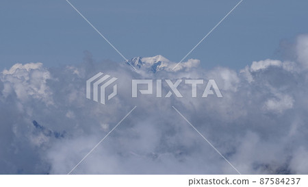 Mont Blanc peak within clouds seen from Switzerland Mont Blanc peak within clouds seen from Switzerland 87584237