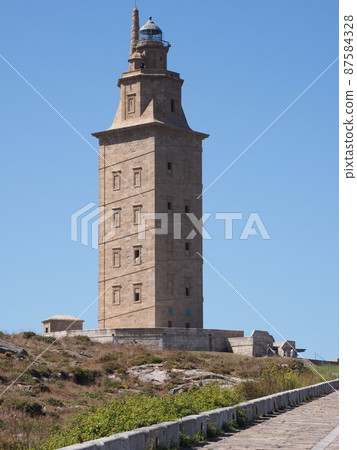 Promenade and tower of Hercules in A Coruna city in Spain - vertical 87584328