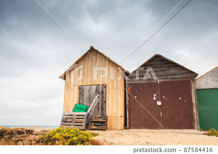 Coastal wooden barns on the beach of Porto Santo Coastal wooden barns on the beach of Porto Santo 87584416