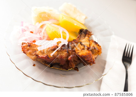 dish of fried pork ribs, rice, potatoes, sweet potato and pickled onions dish of fried pork ribs, rice, potatoes, sweet potato and pickled onions 87585806
